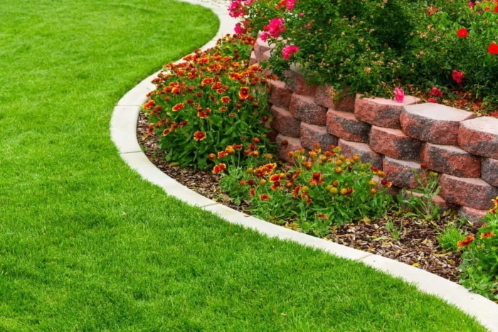 A garden with flowers and a retaining wall designed according to Feng shui principles.