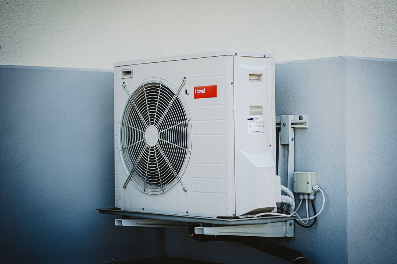 A white AC unit mounted on a wall.