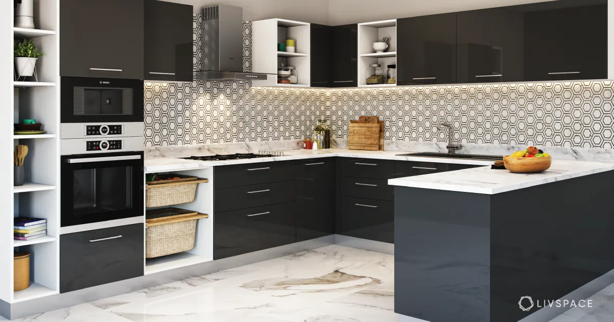 A black and white kitchen with marble counter tops.