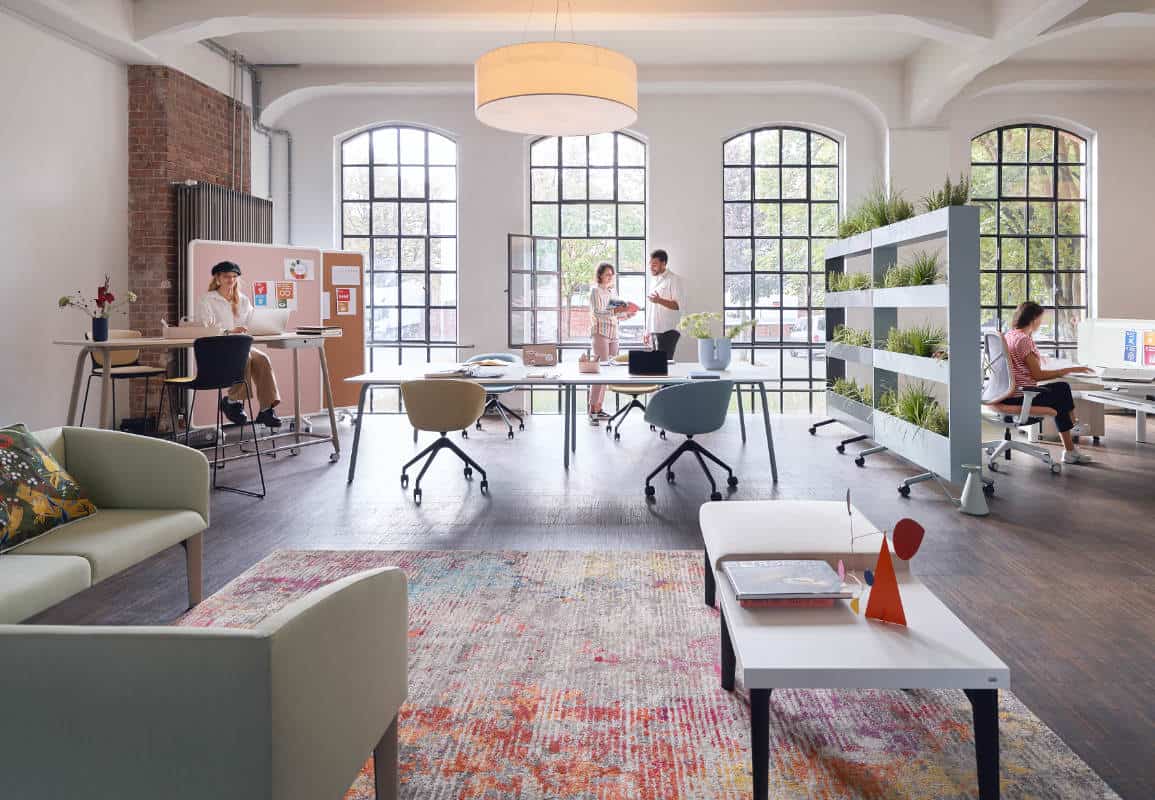 Modern open-plan office space with employees working.