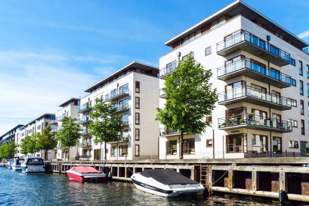 A waterfront condominium with a boat docked in the water.
