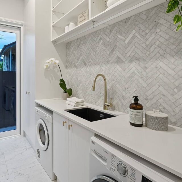 A laundry room with a white washer and dryer.