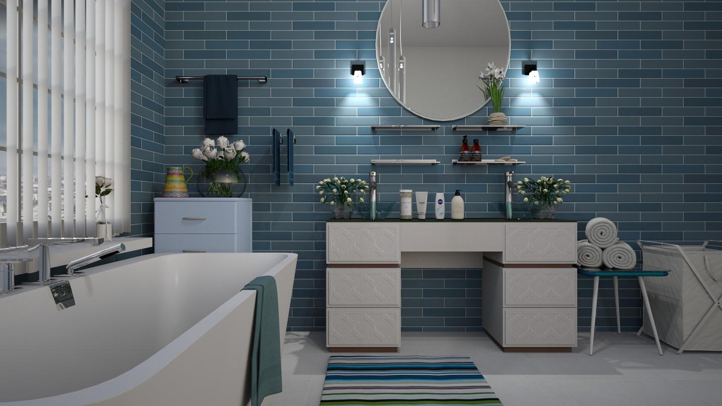 A blue tiled bathroom with a functional and attractive sink.