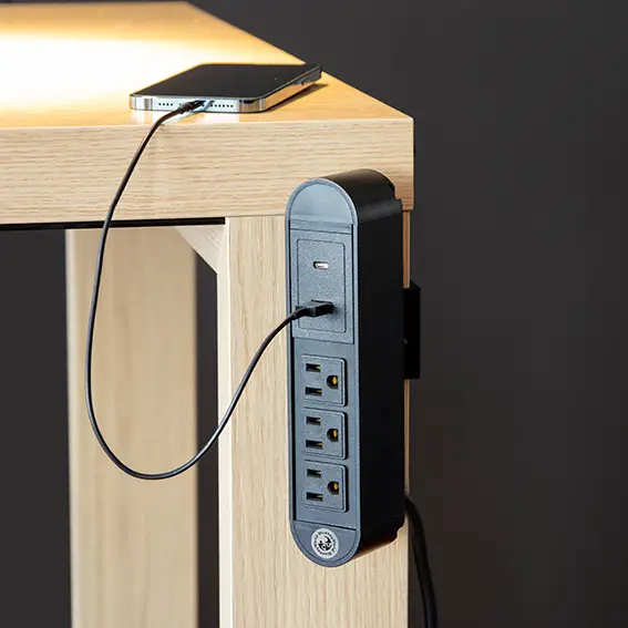 A desk with a built-in phone charger, promoting decluttering.