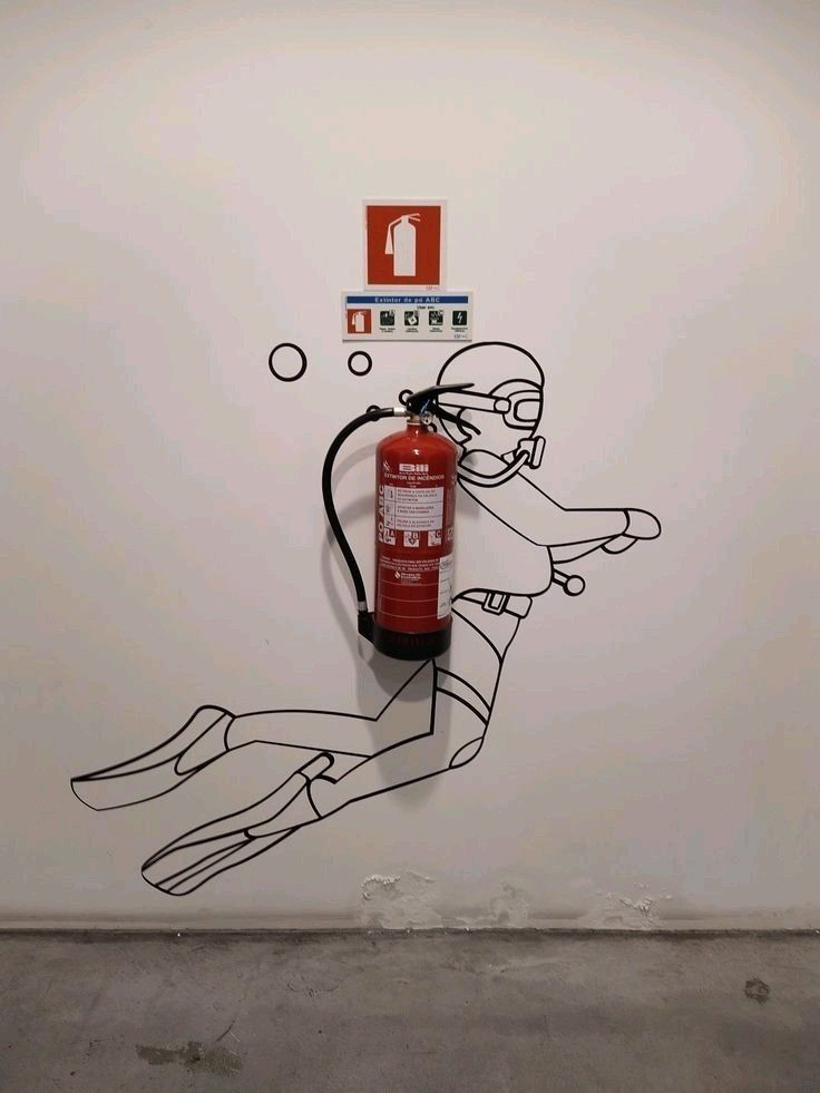 Blending a survival item into the scenery with art: A fire extinguisher drawing on a wall.