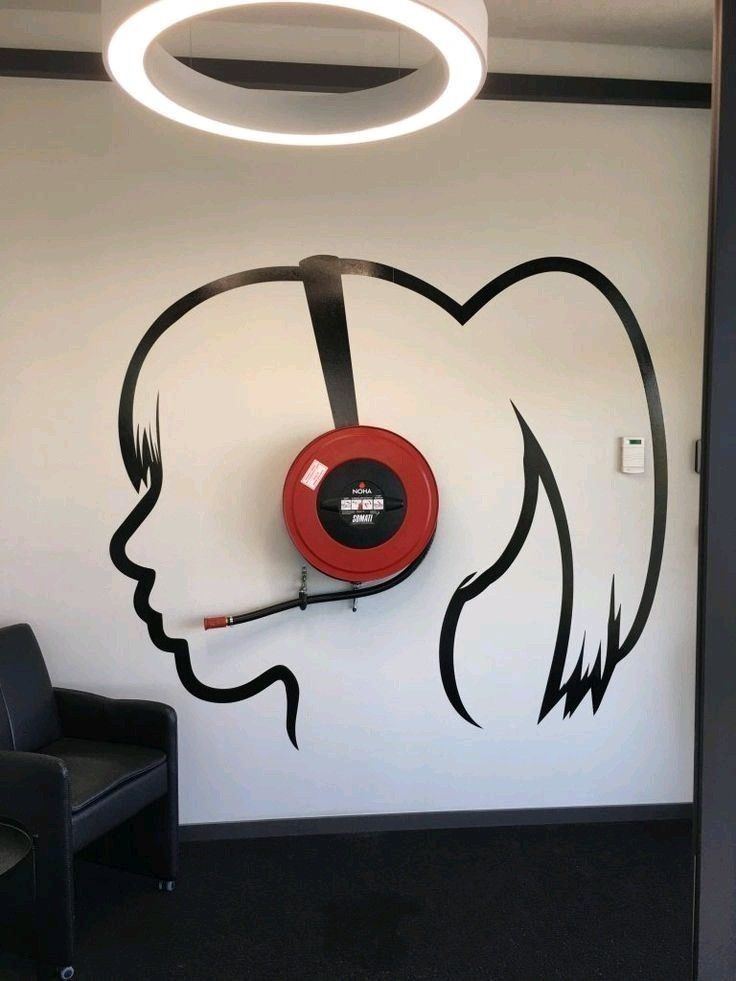 A woman's head with headphones blending art into an office.