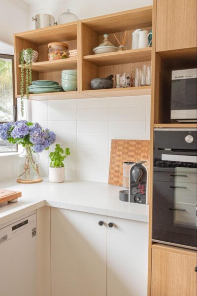 A DIY home project featuring a kitchen with wooden cabinets and a microwave oven.