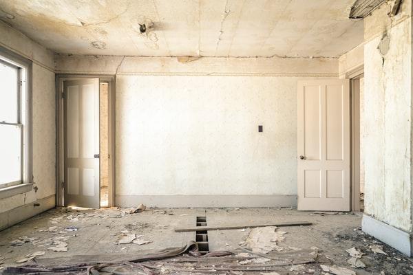 An empty room with walls that have been ripped down, debunking common misconceptions about what home insurance covers.