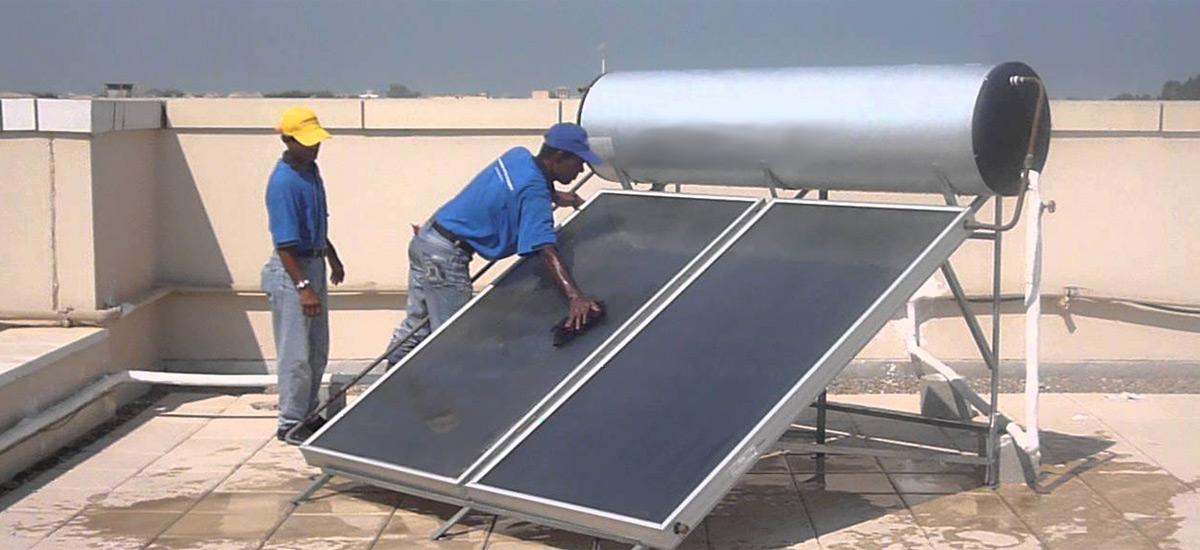 Two men installing a solar water system.