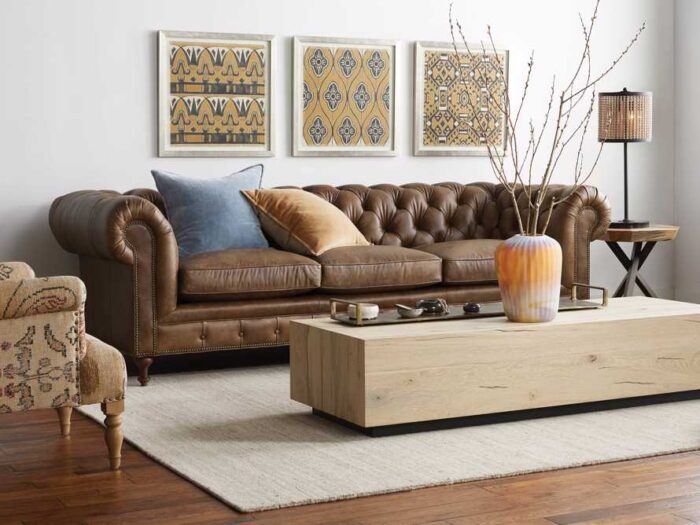 A living room with a timeless brown leather sofa and coffee table.