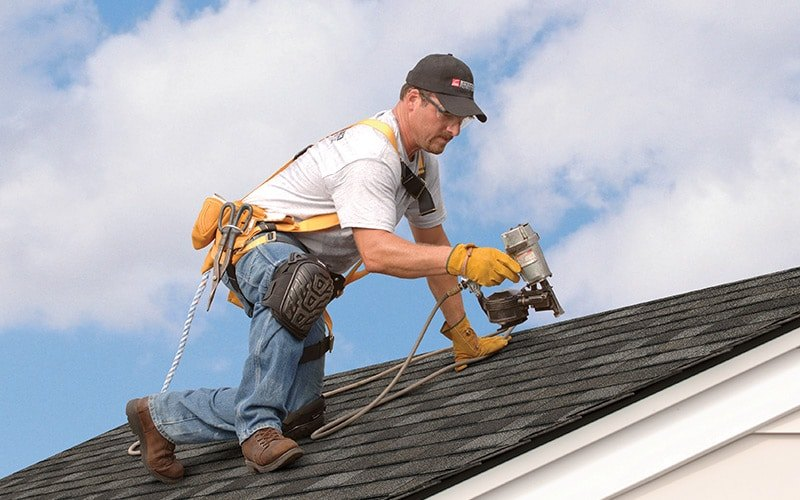 Roofing contractor working on a house.