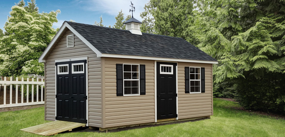 A black shed in a yard.