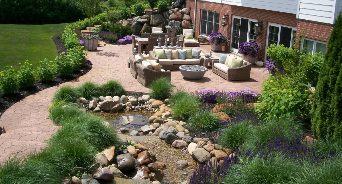 A garden-like oasis with a patio and landscaping.