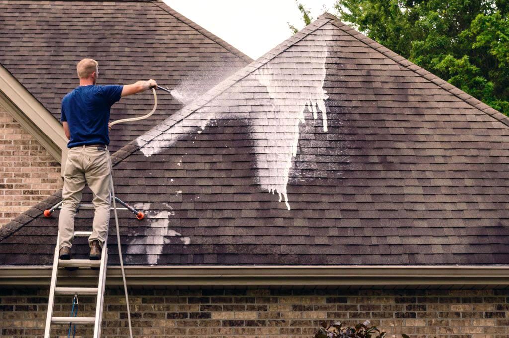A man cleaning a residential roof.