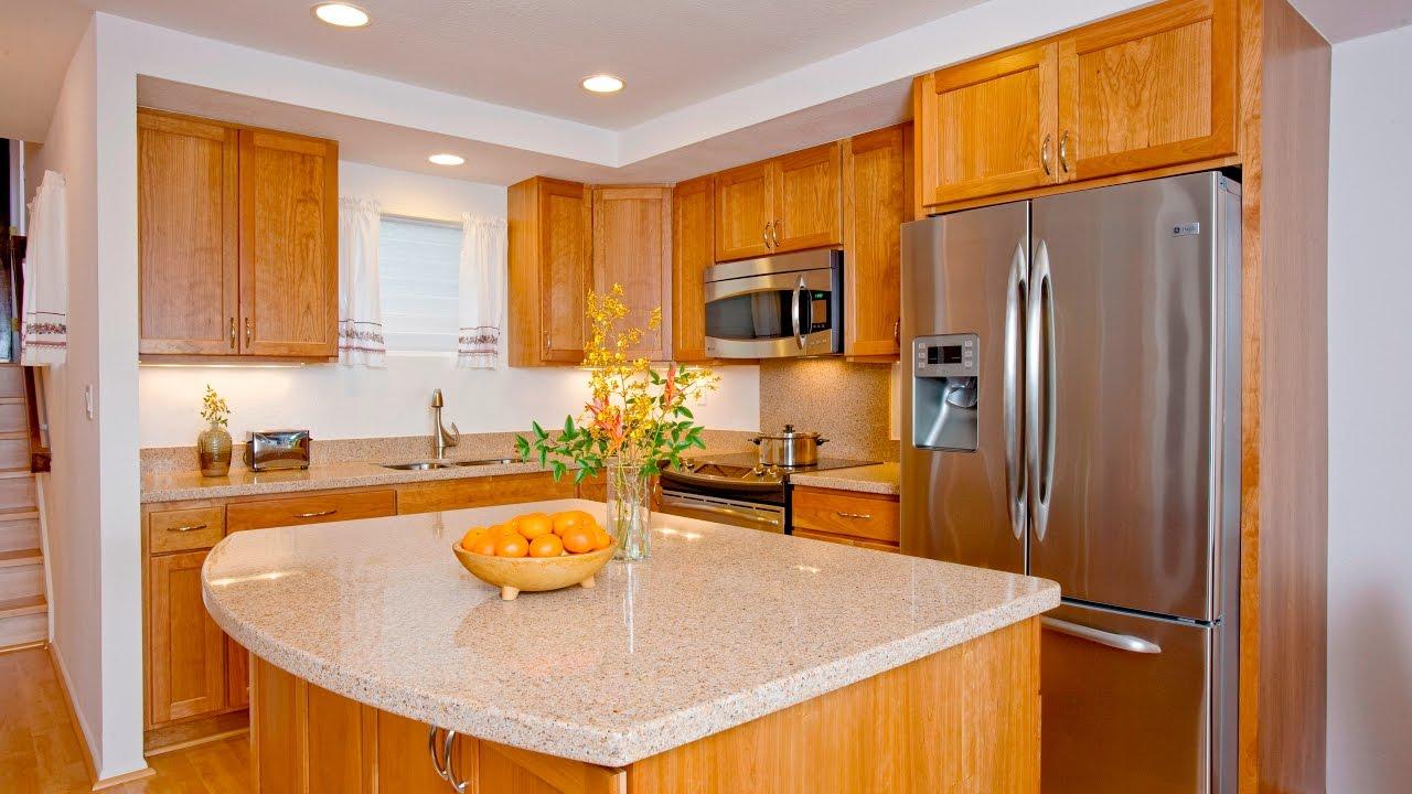 A kitchen with wooden cabinets and a granite counter top designed for home renovation.