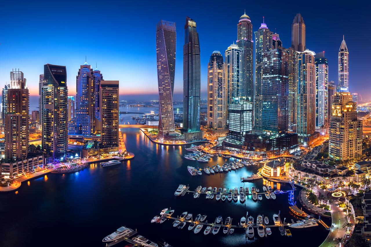 The Dubai Marina lights up the city of Dubai at night.