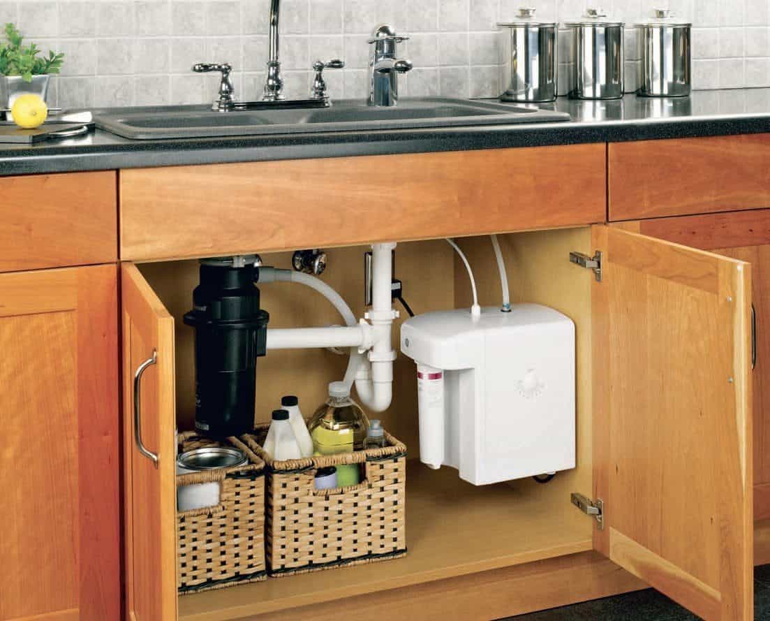 A kitchen with a sink and a water dispenser equipped with water filters.