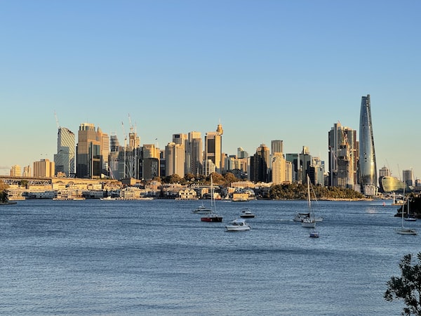 The Sydney skyline seen from a boat on the water offers a picturesque view of the city.
