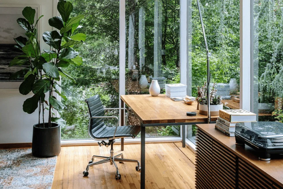 A perfect home office with large windows and a desk.