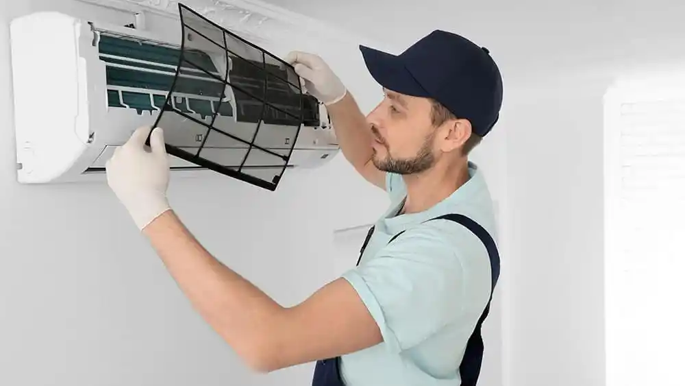 A man repairs an air conditioner.