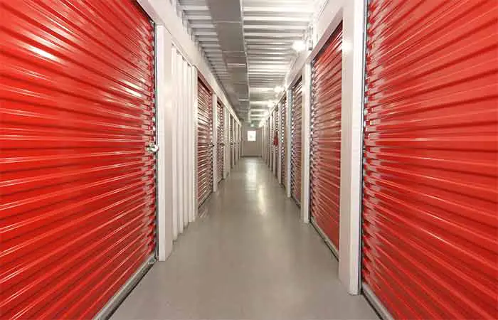 A line of red storage units in a storage facility.