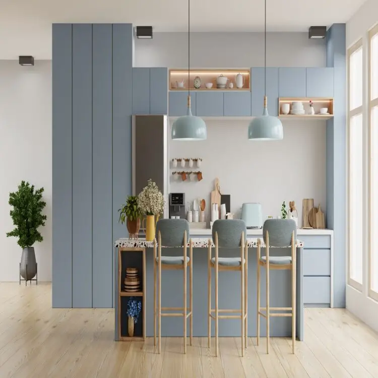 A modern kitchen with blue cabinets and wooden floors.