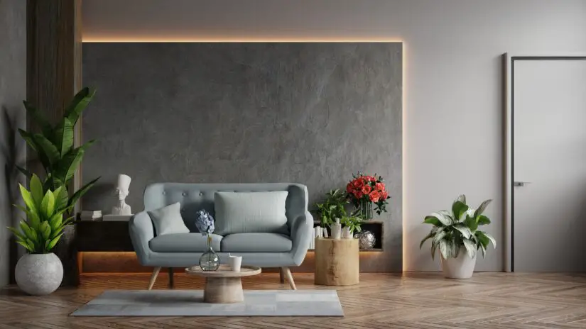 A living room with a grey wall and a blue chair.