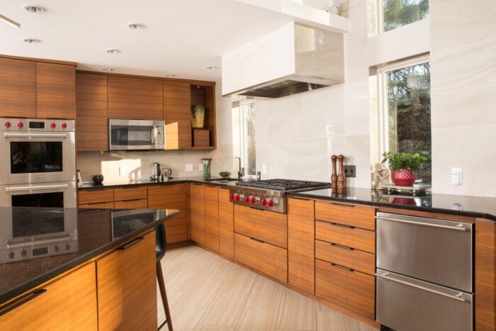 A modern kitchen with wooden cabinets and stainless steel appliances.