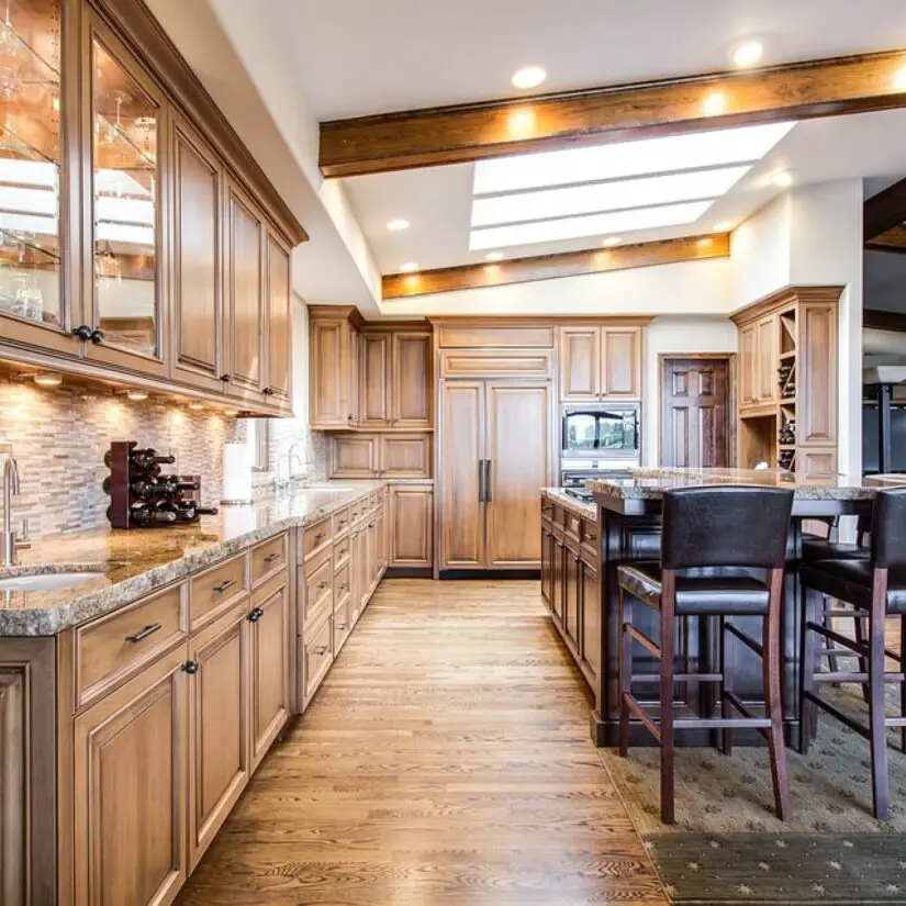 A large kitchen with wooden cabinets and counter tops.