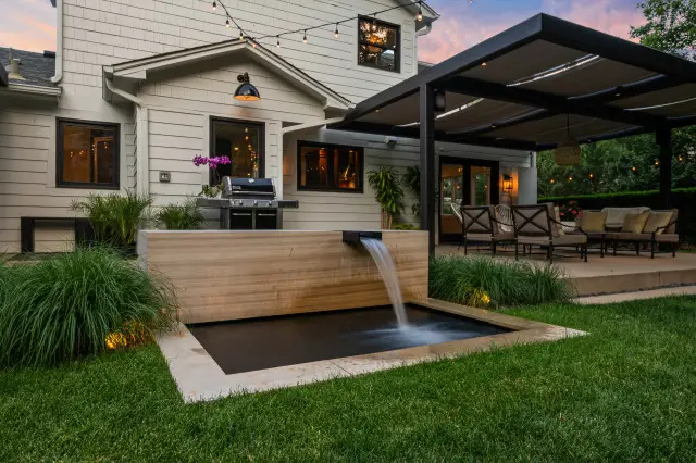 A modern backyard with a water feature and patio design ideas.