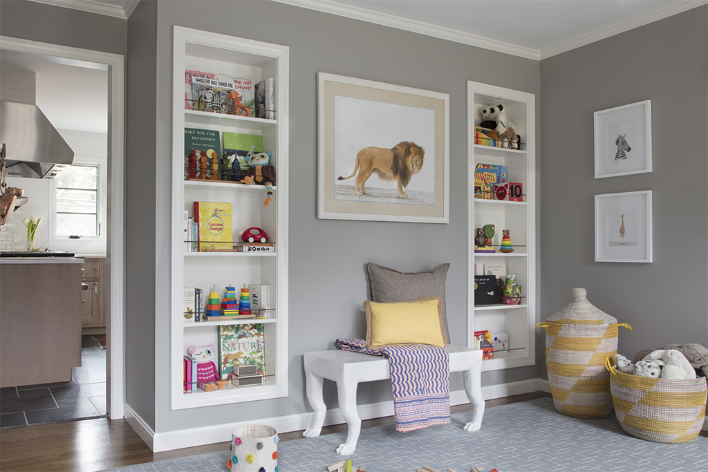 Unused dining room transformed into a child's room with bookshelves and a bench.
