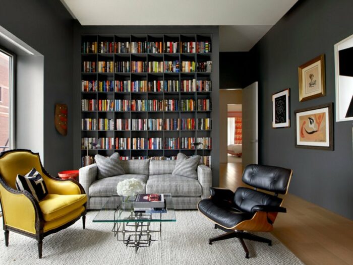 How to make a living room with bookshelves and a yellow chair feel cozy.