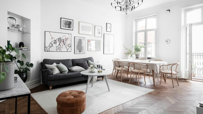 How to make a living room feel cozy with white walls and wooden floors.