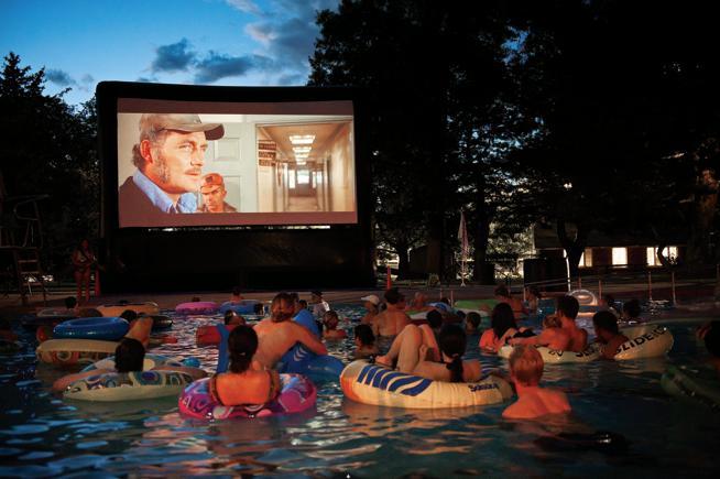 A group of people enjoying a dive-in movie.