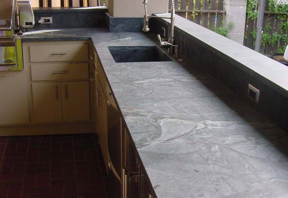 A soapstone kitchen counter with a sink.