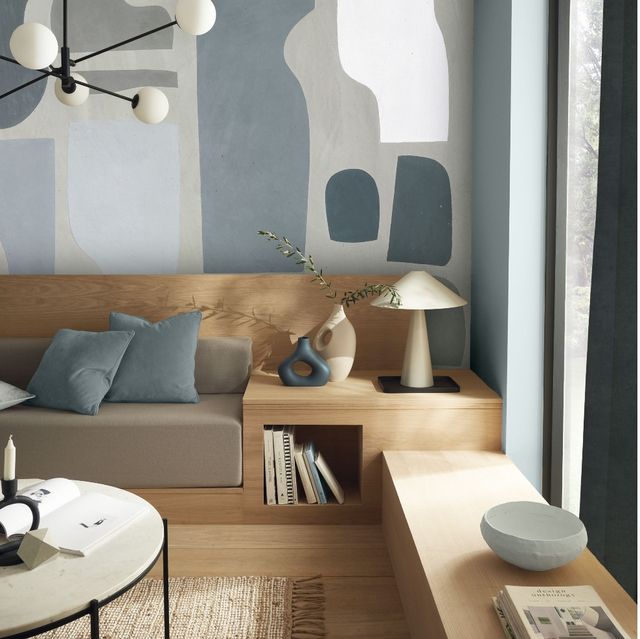 A modern living room with blue walls and carpentry ideas to transform your space.