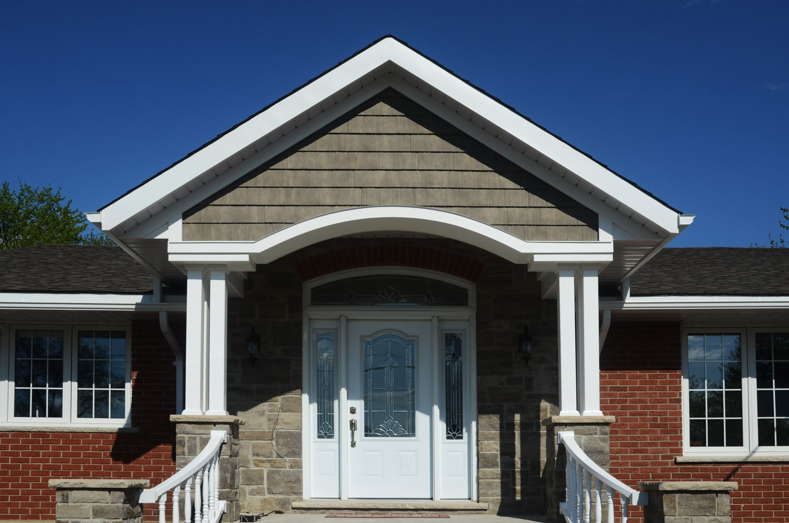 Keywords: brick house, white door

Modified Description: A brick house with a white door and steps.