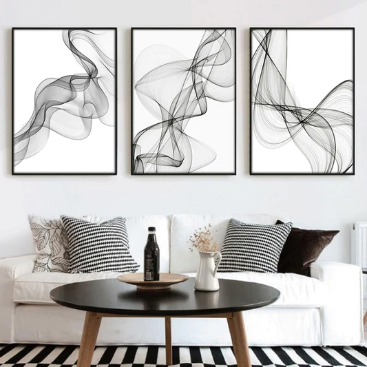 Three black and white abstract framed prints in a living room showcasing The Art of Minimalism.