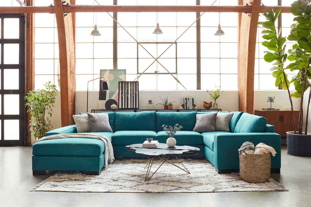 A living room with a sectional sofa and coffee table for selecting the best sofa.