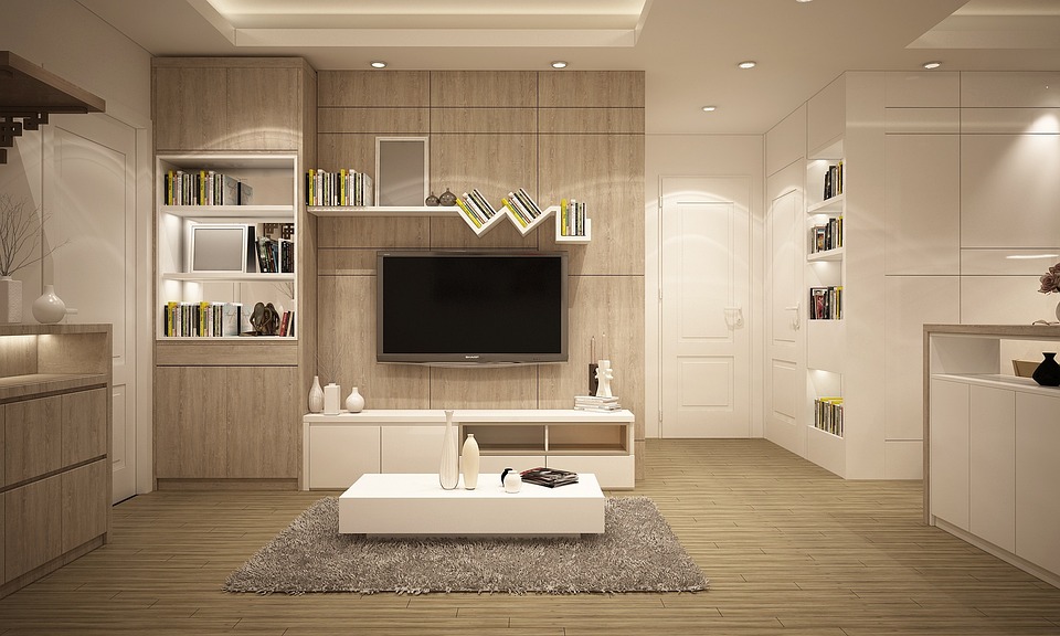 Creating a modern living room with a cozy haven ambiance featuring a TV and bookshelf.