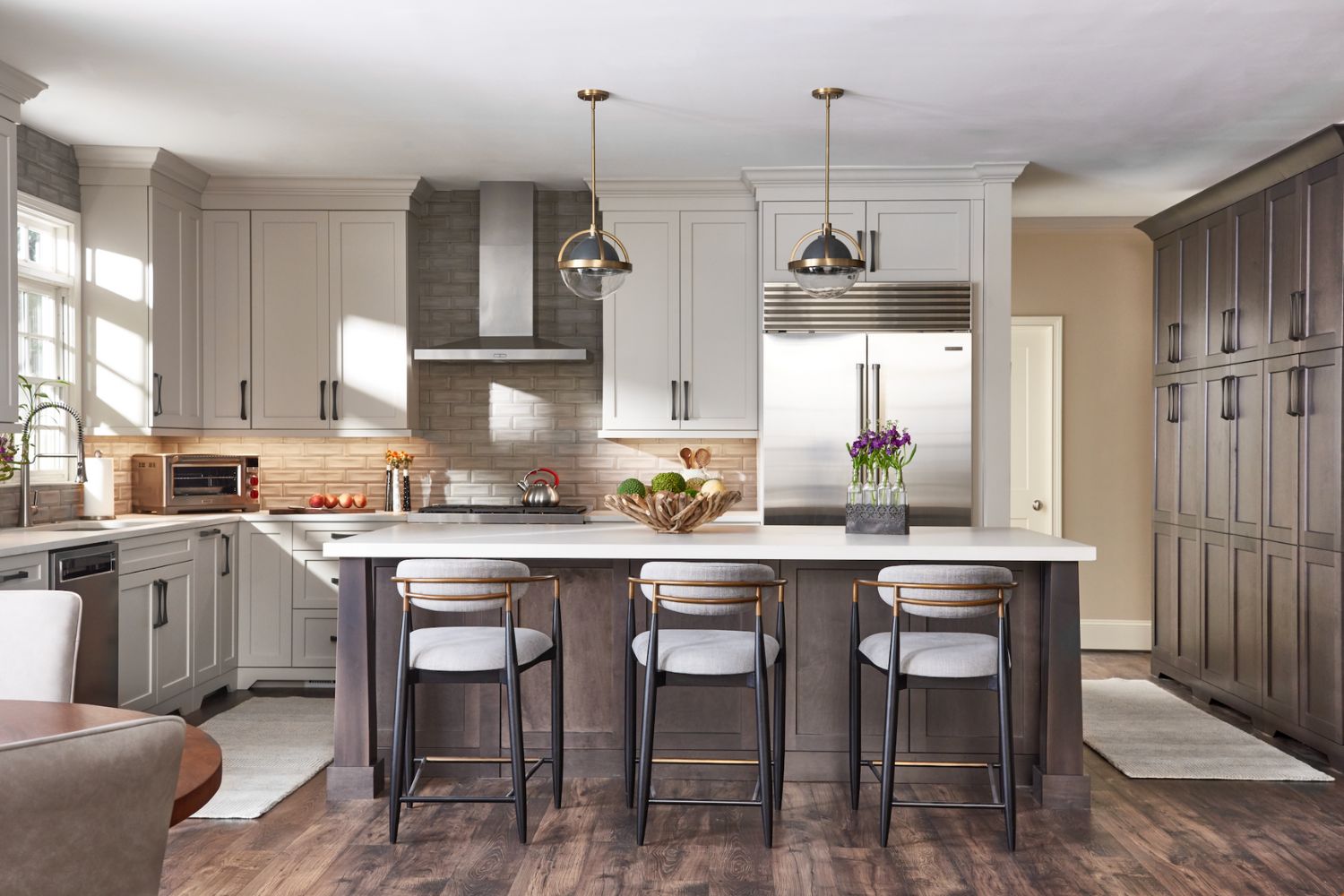 A gourmet kitchen with a center island and stools.