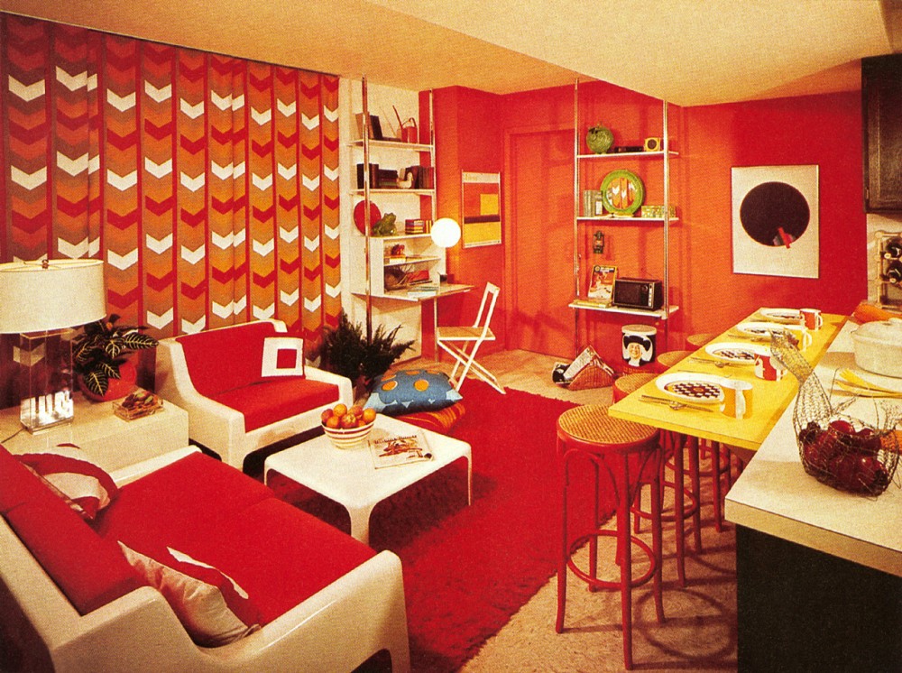 A living room with red and white furniture featuring 70's interior design elements.