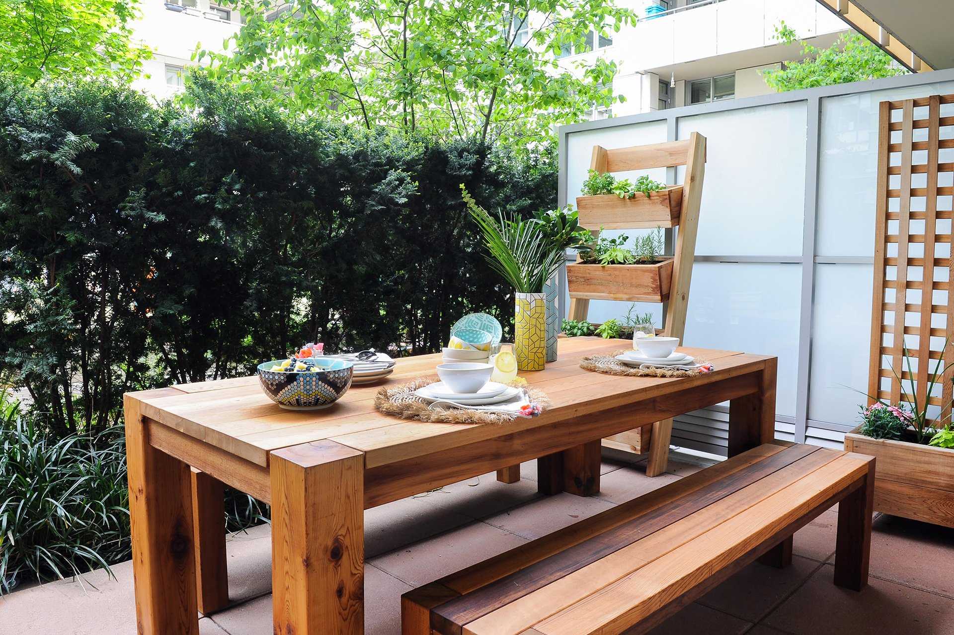 A wooden table and chairs on a balcony, the best outdoor furniture.