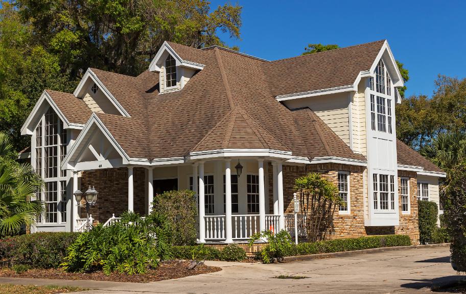 A home with a large front porch and various roof designs.