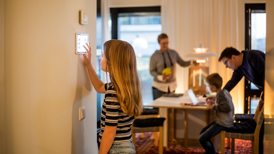 A young girl is using a smart device in her upgraded living room.