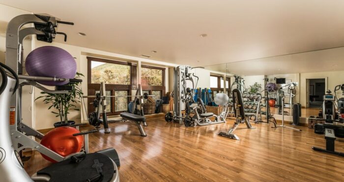 An expansive gym room with tons of state-of-the-art equipment.