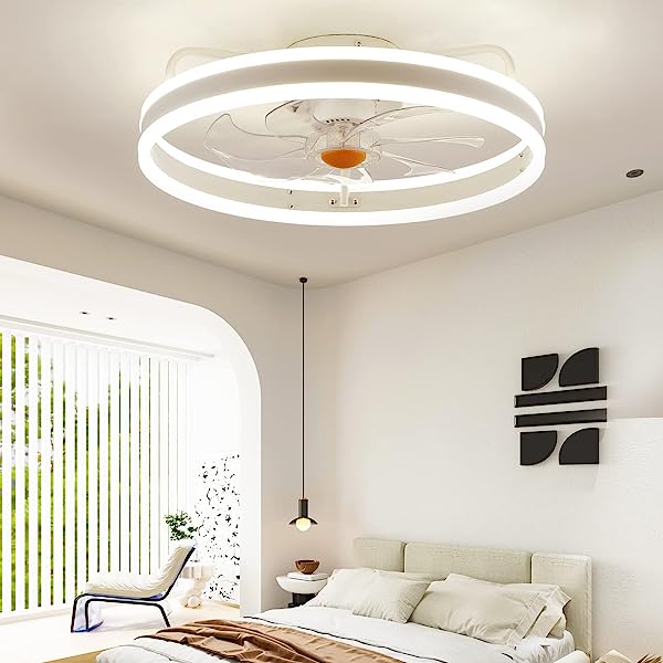 A bedroom with a bed and a ceiling fan with lights.