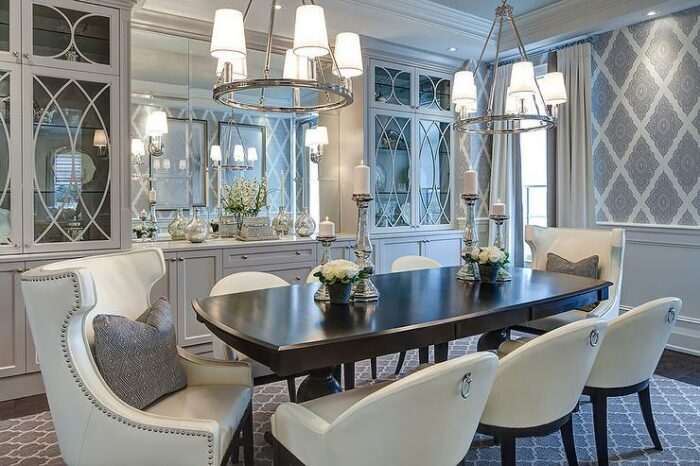 A formal dining room with a white table and chairs featuring a built-in dining room cabinet.