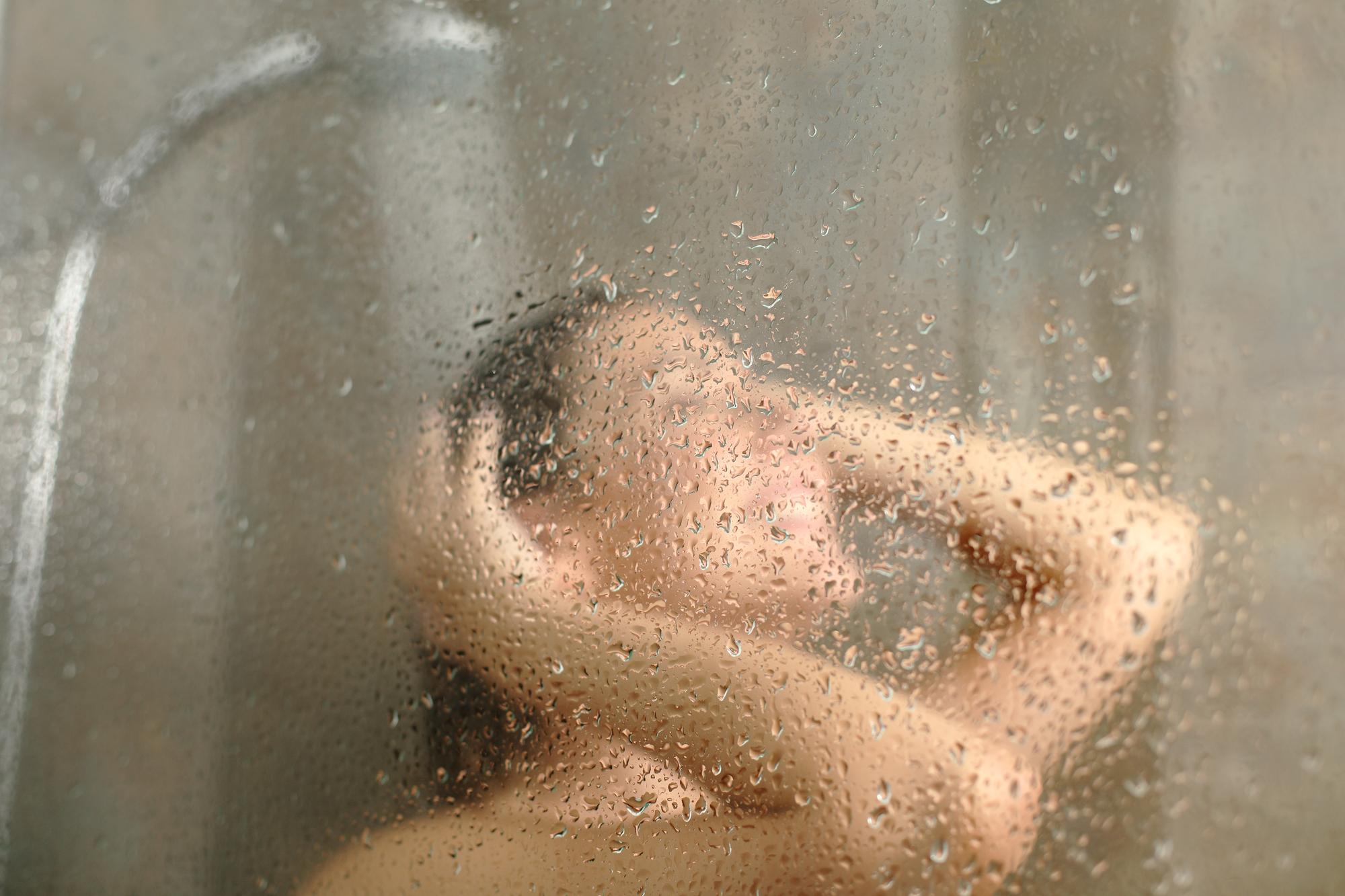 A woman enjoying a hot shower.