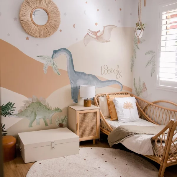 A child's room with dinosaur wall decals.